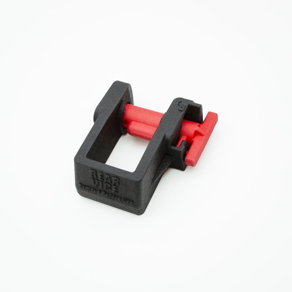 A black plastic quick-release barrel clamp with red internal components, shown on a clean white background. The brand name 'Bear Vise' is embossed on the side.